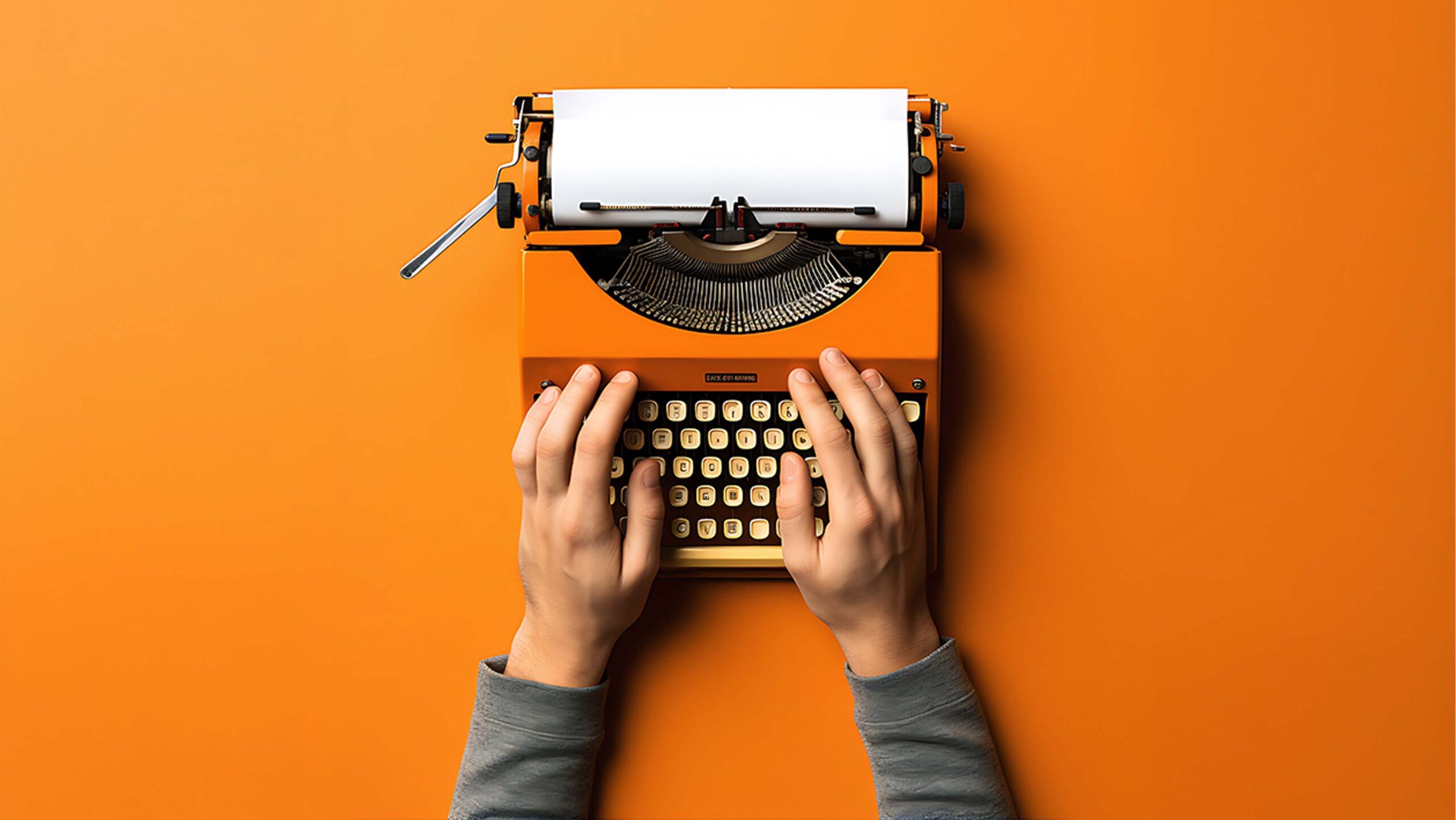 Script writing service with hands typing on orange typewriter